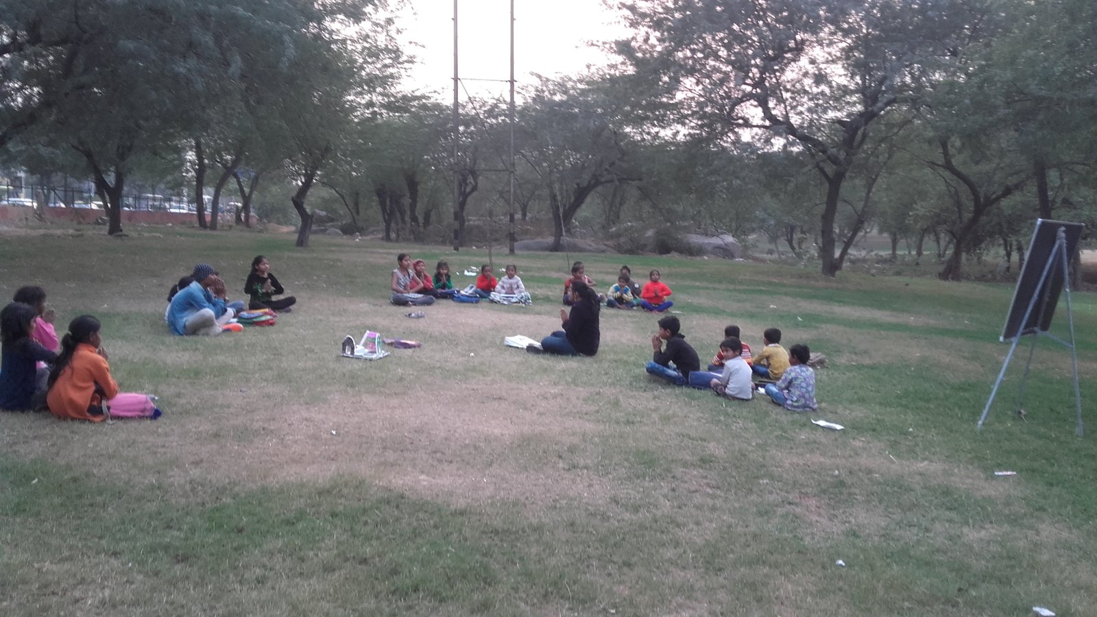 Children gathered for an outdoor learning session in a park