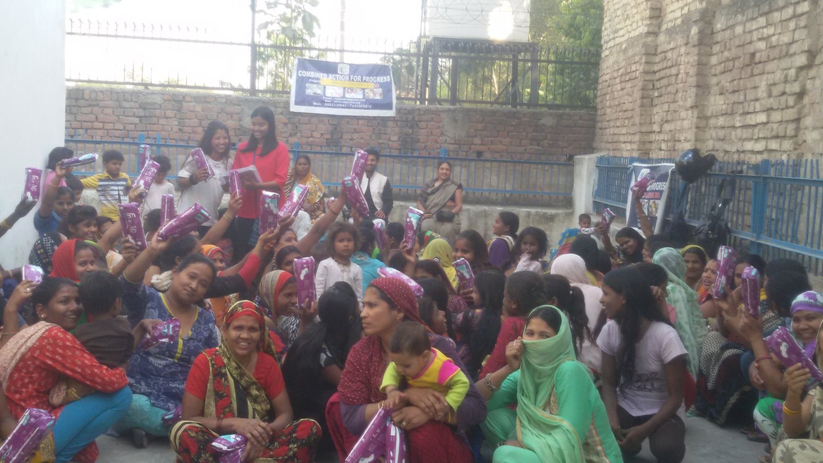 Women holding sanitary kits during an ARP India health and hygiene outreach programme