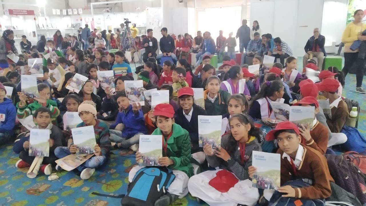 Students holding educational materials at an ARP India event